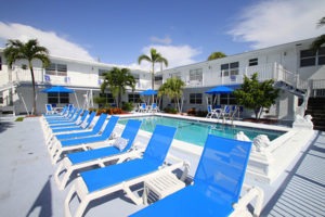 Sea Spray Inn. This is a picture of the pool with the blue lounge chairs in front and the hotel in background.